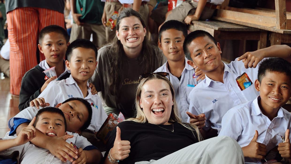 Eleven22 mission team laughing with a group of kids