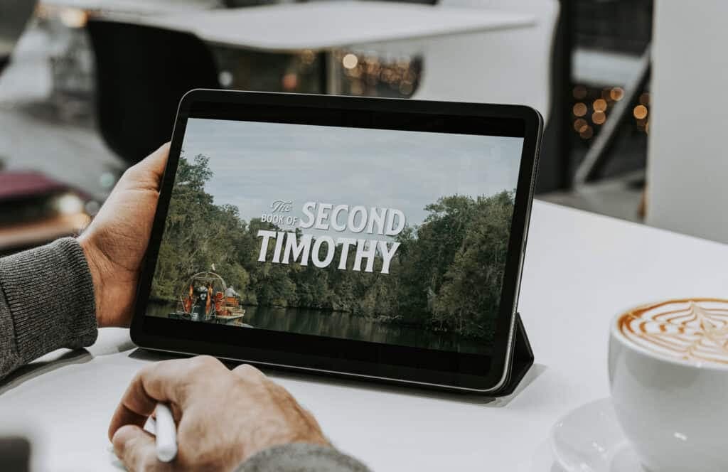 A tablet on a cafe table showing The Book of Second Timothy series