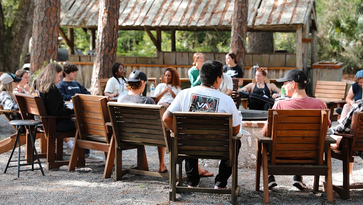 A group gathered in the outdoor seating area at the Eleven22 Retreat Center