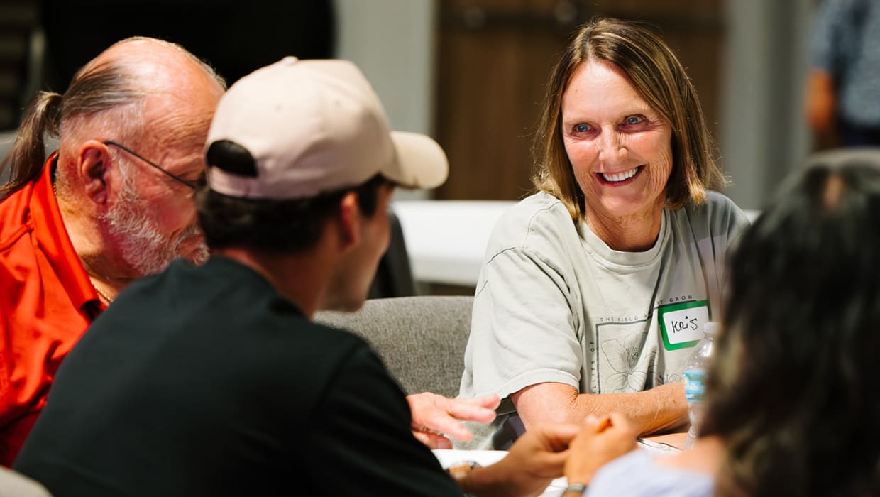 Senior adults talking and laughing around a table