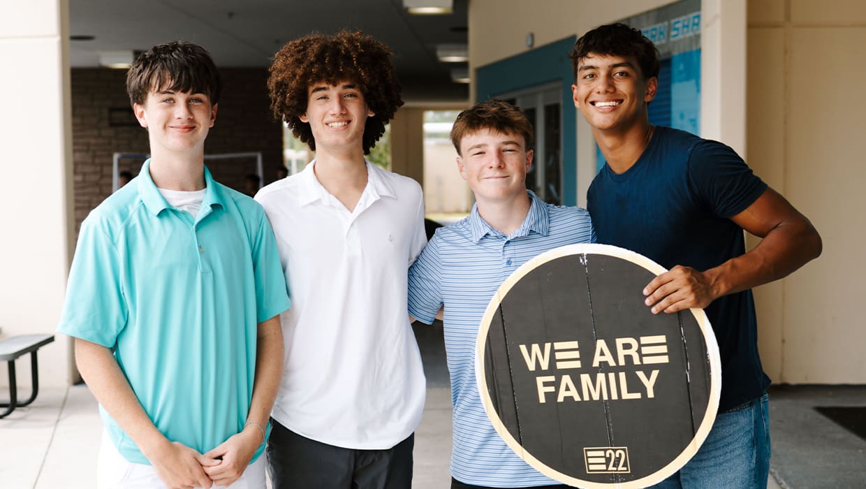 Eleven22 Students holding a We Are Family sign