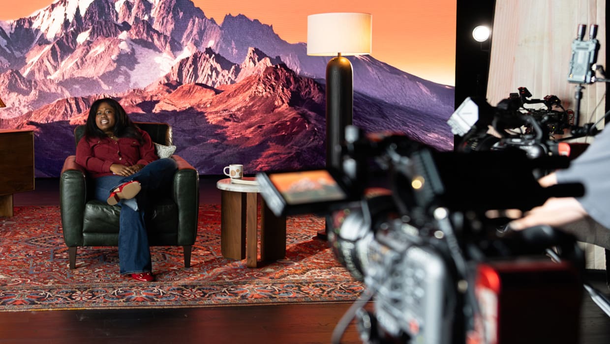 A woman sharing her story on camera on the Eleven22 Stories set